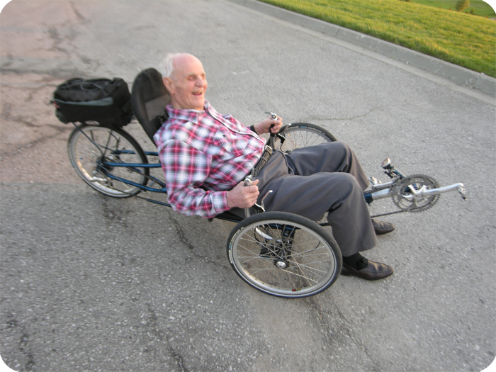 Kenneth Heim riding a tricycle